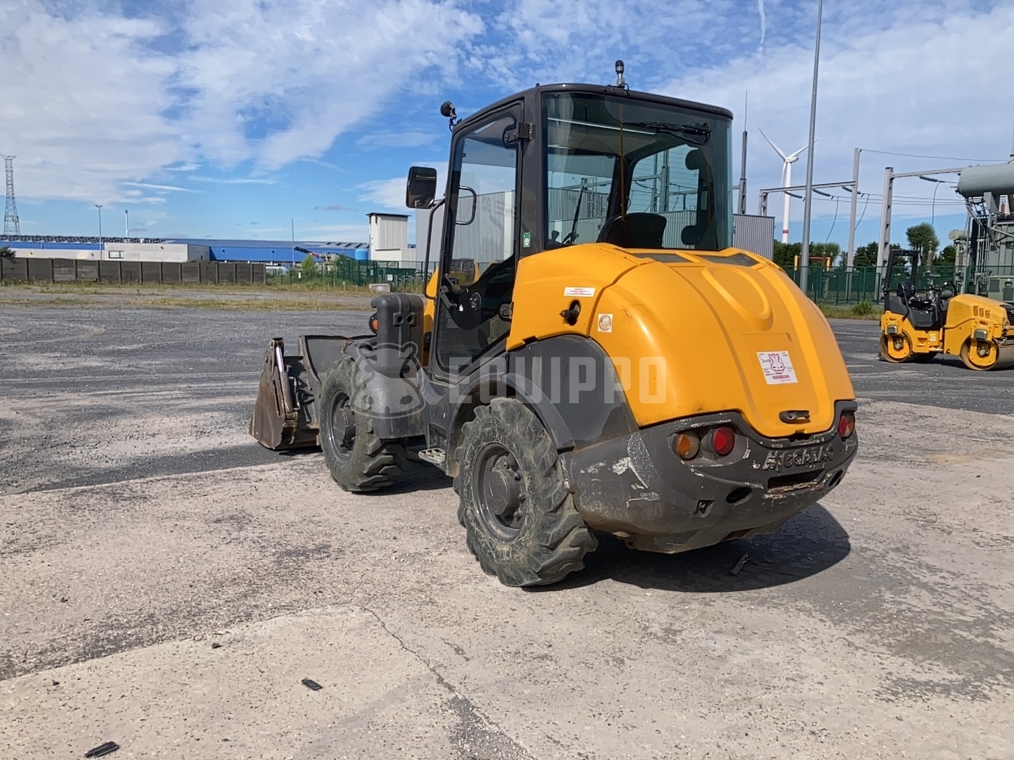 Mecalac AX700 with 4-in-1 bucket and forkboard - - Used Wheel Loader