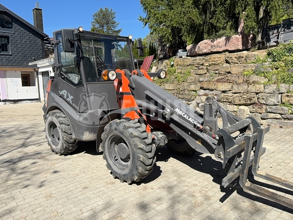 Picture of the Mecalac Ax 850 with forks and loader-bucket